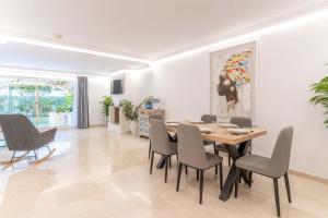 a dining room with a table and chairs at VIP Dominion Beach Estepona in Estepona