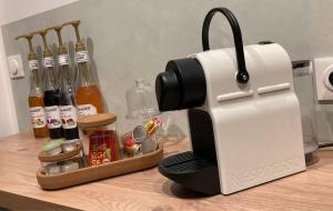 a toaster sitting on top of a counter next to a tray of condiments at SPA La Maison du Bonheur Suite avec Spa prive pres d Arras in Roeux