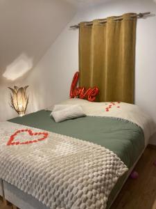 a bedroom with a bed with a curtain on it at Hébergement-spa-Roeux in Roeux
