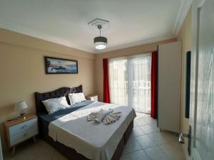 a bedroom with a large bed and a window at Ng Hisar Apart Hotel in Fethiye +37 photos