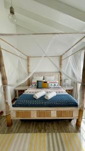a bedroom with a bed in a tent at The Wooden House in Plettenberg Bay +32 photos
