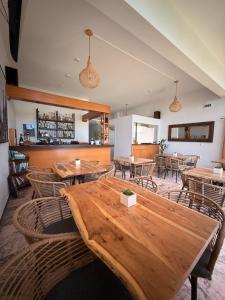 a dining room with wooden tables and chairs at Nikoli Apartments in Benitses