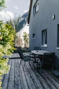 a patio with a table and chairs on a wooden deck at NaturparkResort Salzahalt in Wildalpen