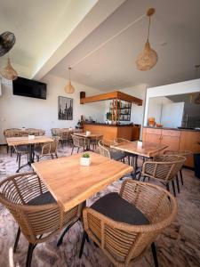 a dining room with wooden tables and chairs at Nikoli Apartments in Benitses