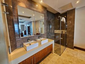 a bathroom with two sinks and a shower at Exquisite Penthouse Apartment 712 at La Montagne by First Private Stays in Ballito +24 photos