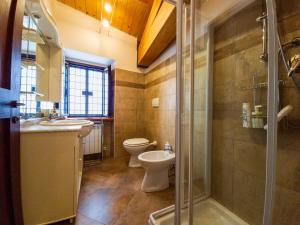 a bathroom with two sinks and a toilet and a shower at Monti sibillini house in Pievebovigliana +15 photos