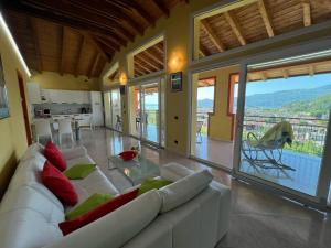 a living room with a white couch and a table at Penthouse Valentino in Intra