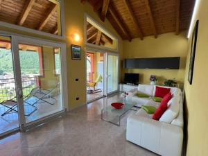 a living room with a white couch and a table at Penthouse Valentino in Intra