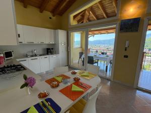 a kitchen with a table and a view at Penthouse Valentino in Intra