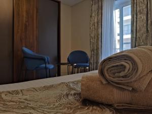 a hotel room with a bed with towels on it at Luxury Seaside Eastlynn Flat Ghadira, Mellieha in Mellieħa