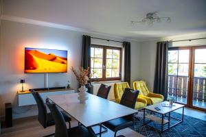 a living room with a table and chairs at Ferienwohnung Pistenblick in Winterberg +37 photos