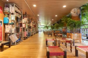 a room with tables and chairs in a store at Nestay in Karnāla