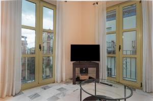 Televízia a/alebo spoločenská miestnosť v ubytovaní San Julian Apartment