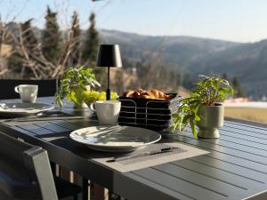 a table with plates of food and plants on it at Ferienwohnung Pistenblick in Winterberg