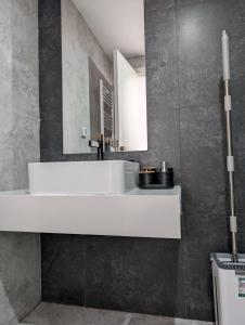 a bathroom with a white sink and a mirror at Dar GAMRA Luxury apartment with sea view in Hammamet Sud