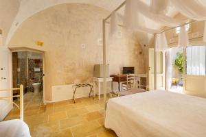 Postel nebo postele na pokoji v ubytování Masseria Li Capperi by Perle di Puglia