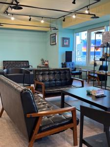 una sala de espera con sofás y mesas de cuero en Pathways Hostel, en Kaohsiung