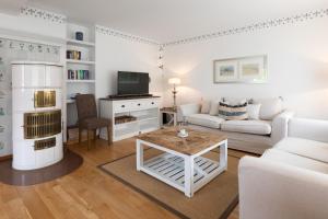 a living room with a couch and a table at Wohnung 14 Am Januspark in Juist