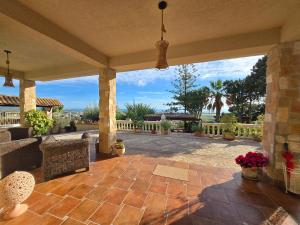 an outdoor patio with a view of the ocean at BeB Villa Ylenia in Agrigento