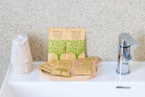 a bathroom sink with a book on top of it at Villa De Nuzzo - Bed & Breakfast in Torre San Giovanni Ugento