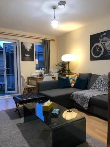 a living room with a couch and a table at Lovely Townhouse with Garden and Parking in Camden Central London in London