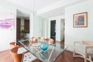 a dining room with a glass table and chairs at Appartamento fronte mare in Portovenere +30 photos