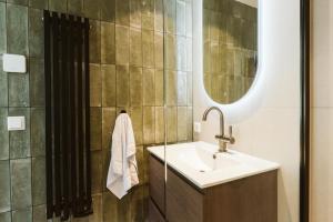 a bathroom with a sink and a mirror at Dorpsweg 9 - Ouddorp in Ouddorp +21 photos