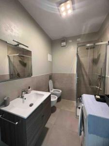 a bathroom with a sink and a toilet and a shower at Appartamento fronte mare in Portovenere
