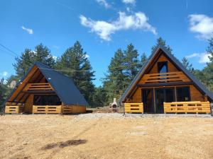 a large log cabin with a black roof at ROMANIJA vikendice in Sarajevo