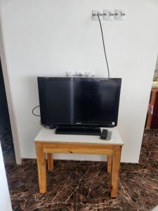 a flat screen tv sitting on top of a wooden table at Beautiful F3 with Sea View in La Reghaia/Boudouaou