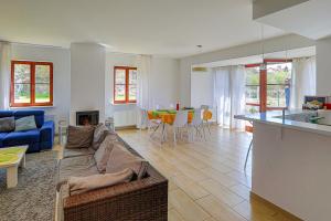 a living room with a couch and a table at Willa Basztowa 5 in Pasym