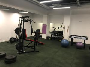 a gym with weights and exercise equipment in a room at Exclusive Apartments Porta Mare Marina - Swimming Pool & Sauna by Renters Prestige in Dziwnów