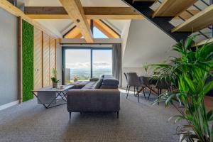 a living room with a couch and a table at Villa Revere - luksus w sercu Podhala in Nowy Targ +125 photos