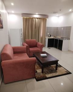 a living room with a couch and a coffee table at فندق زهرة جدة in Jeddah