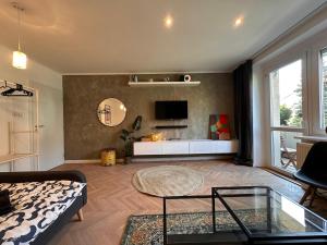 a living room with a couch and a tv at Haban Haus in Bratislava