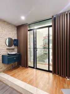 a living room with a large sliding glass door at Paradise Hotel Ton Duc Thang by Luxe Hospitality in Hanoi