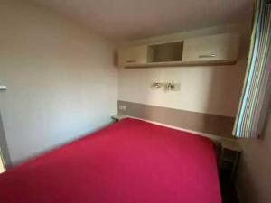 a small room with a red bed in it at Camping 5 étoiles - Parc aquatique - eebdba in Mézos
