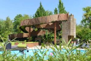 a pavilion with a pool in the middle of a park at Camping 5 étoiles - Parc aquatique - eebdba in Mézos