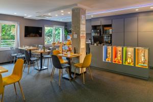 a restaurant with tables and chairs and a bar at Nest Style Valencia in Valencia