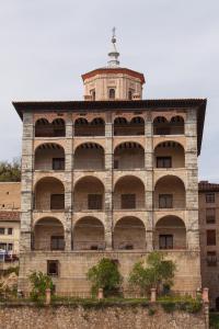 a large brick building with a clock tower on top at Hostal Peñacárdena in Igea