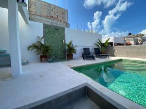 a swimming pool in the backyard of a house at Villas Chukum in Isla Mujeres