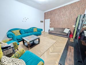 Una sala de estar con sofás azules y una mesa. en Lovely 2BR Apartment in Praterstern Area, en Viena