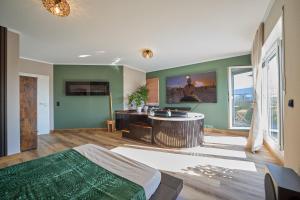 a room with a bed and a tub in it at Home of spa in Mainz