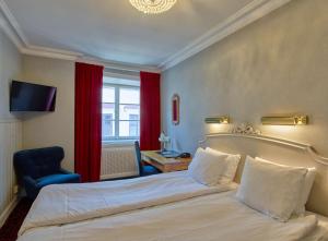 a hotel room with a bed and a chair at Scandic Gamla Stan in Stockholm