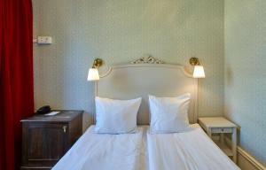 a bedroom with a bed with two white pillows at Scandic Gamla Stan in Stockholm