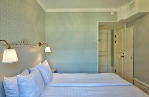 a bedroom with a large bed with blue walls at Scandic Gamla Stan in Stockholm