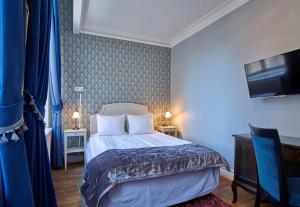 a hotel room with a bed and a tv at Scandic Gamla Stan in Stockholm