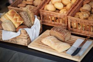 a table with baskets of bread and baskets of pastries at Scandic Gamla Stan in Stockholm