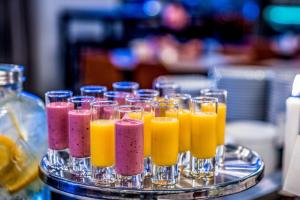 a tray of glasses filled with different colored juice at Scandic Gamla Stan in Stockholm