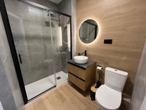 a bathroom with a toilet and a sink and a shower at Apartamento Solimar in Torre del Mar +28 photos